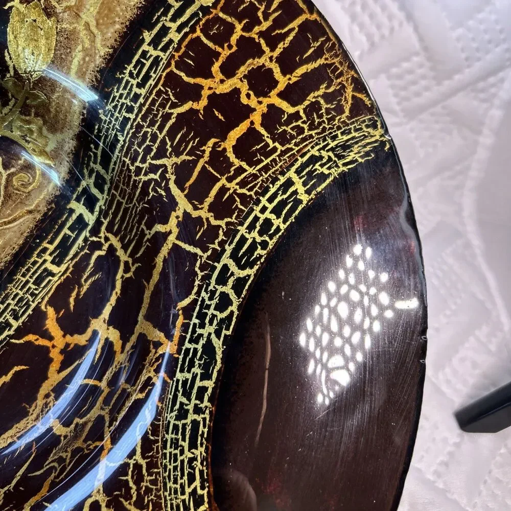Glass bowl features an asymmetrical shape with a striking black and gold crackle